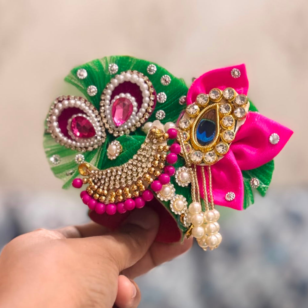 Handcrafted emerald green and pink Morpankh Rajsi Laddu Gopal Ji Poshak with designer Mukut featuring peacock feather embroidery, pearl work and premium Shringar by Bhavyaam.