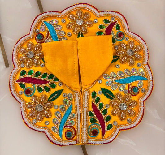 Decorative yellow fabric with floral patterns on a white background
