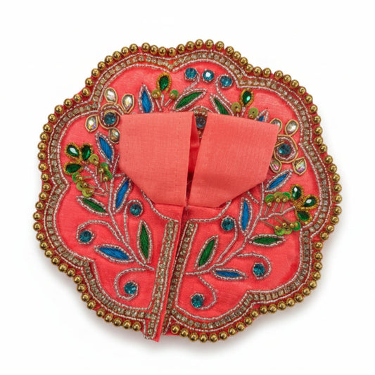 Decorative pink pouch with floral patterns and embellishments on a white surface.
