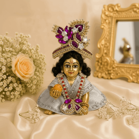 Decorative figurine of a deity with intricate jewelry on a beige background
