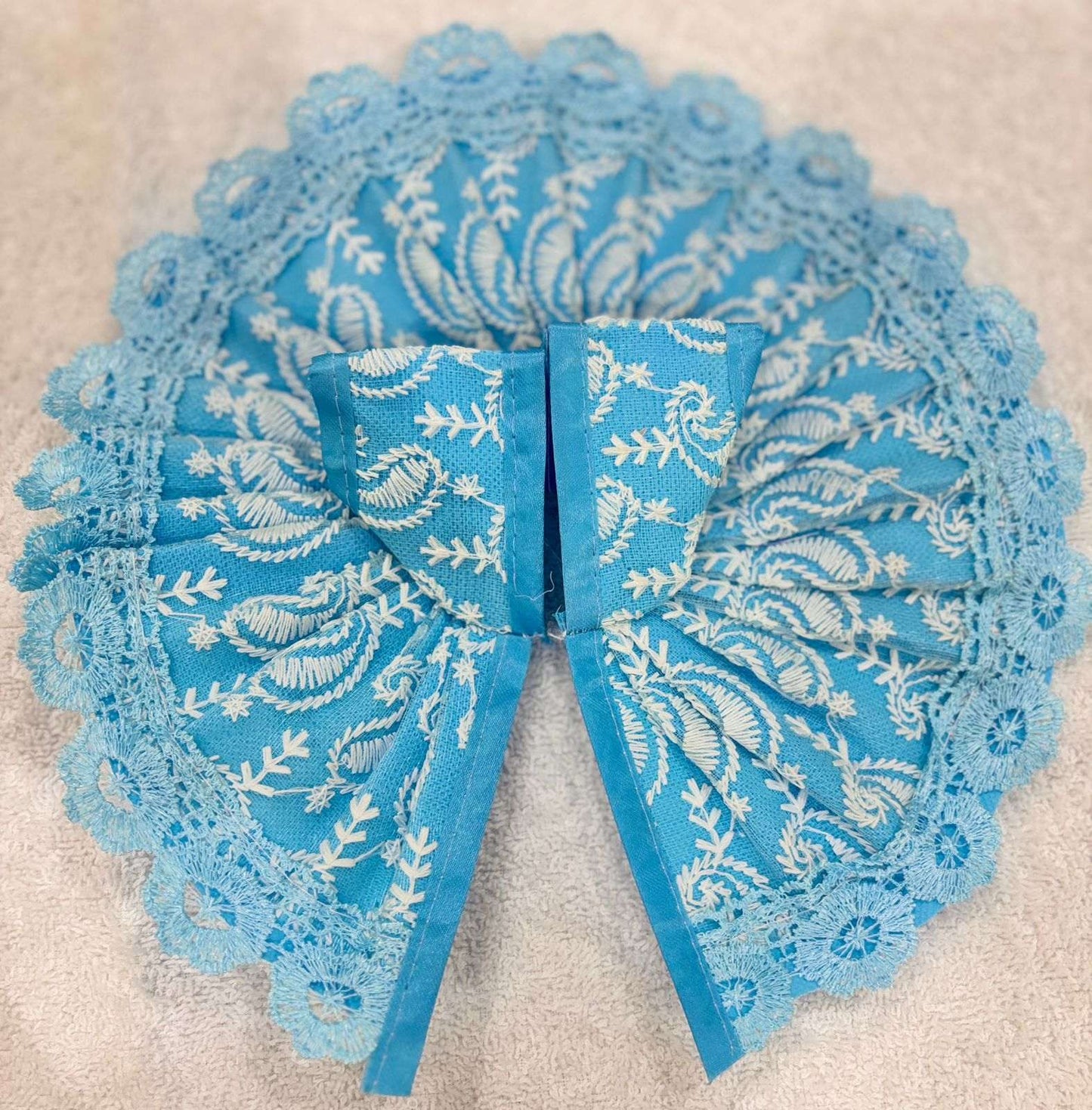 Blue lace bow on a beige background