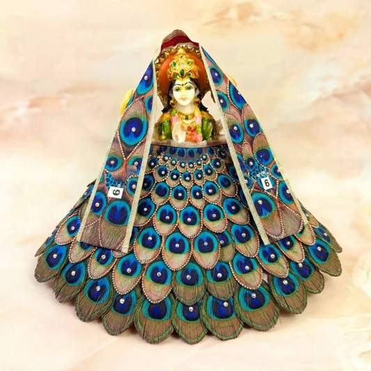 Bhavyaam Mayur Vaibhav handcrafted Lehnga Patka set for Mata Rani, Lakshmi Ji and Ganesh Ji featuring a peacock feather inspired design with stone embellishments and festive shringar.