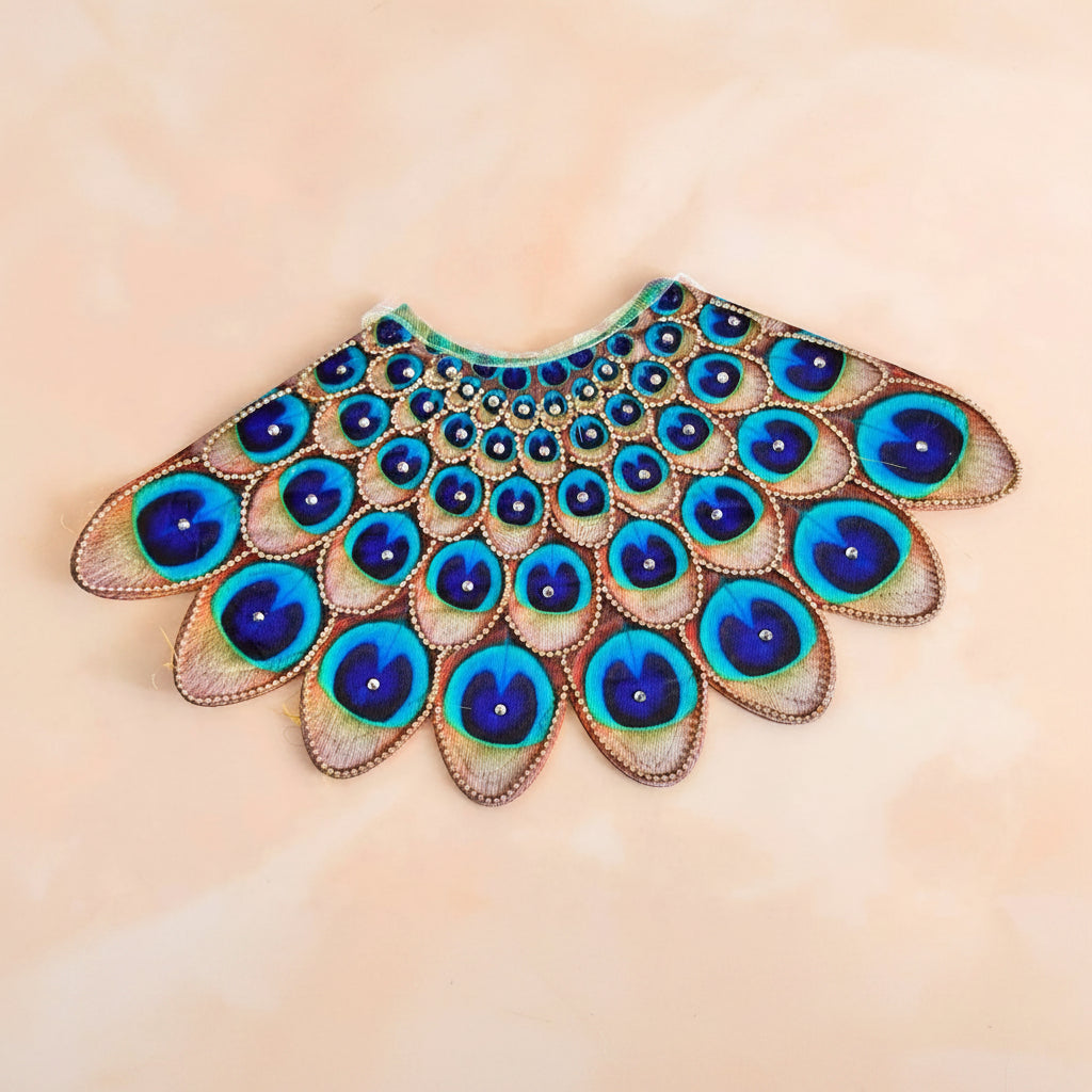 Bhavyaam Mayur Vaibhav handcrafted Lehnga Patka set for Mata Rani, Lakshmi Ji and Ganesh Ji featuring a peacock feather inspired design with stone embellishments and festive shringar.