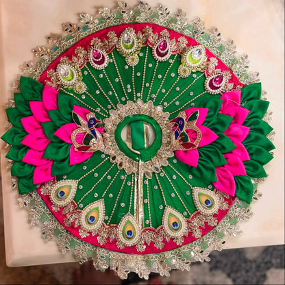 Handcrafted emerald green and pink Morpankh Rajsi Laddu Gopal Ji Poshak with designer Mukut featuring peacock feather embroidery, pearl work and premium Shringar by Bhavyaam.