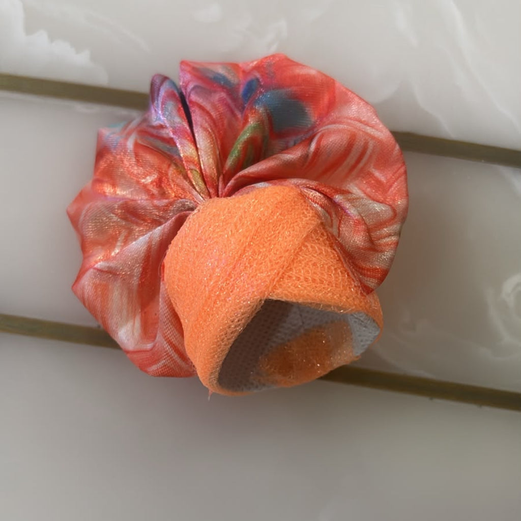 Orange and multicolored patterned headband on a white background