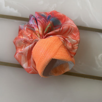 Orange and multicolored patterned headband on a white background