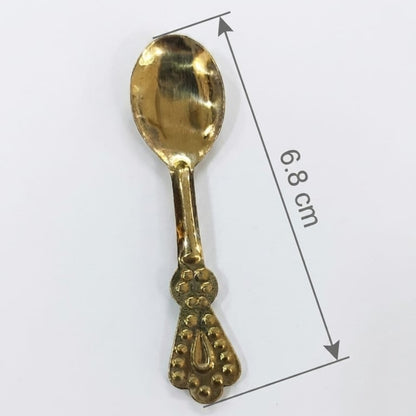 Gold decorative spoon with measurement details on a white background