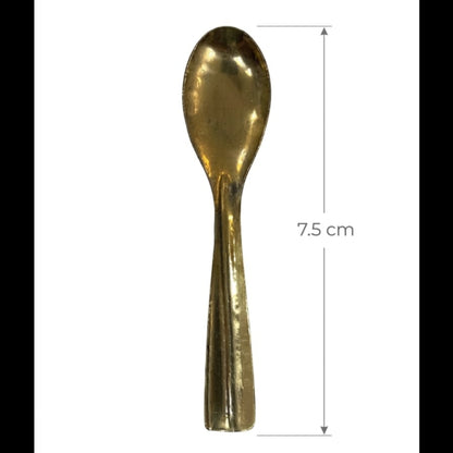 Gold spoon with measurement label on a white background