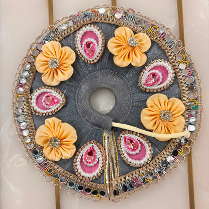 Decorative headband with flowers and embellishments on a neutral background