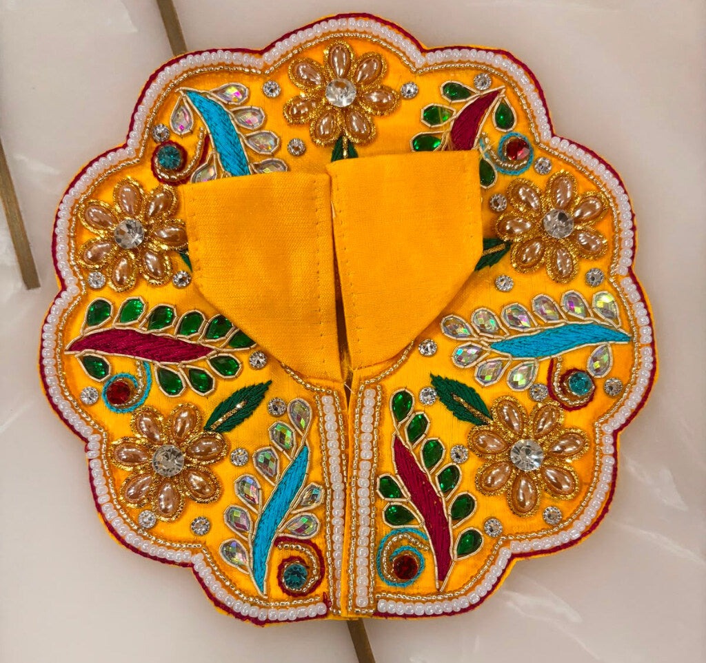 Decorative yellow fabric with floral patterns on a white background