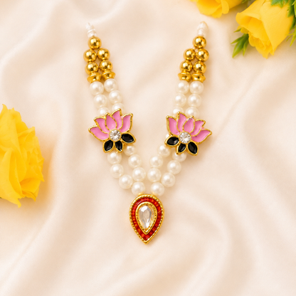 Pearl necklace with pink floral pendants and yellow roses on a beige fabric background