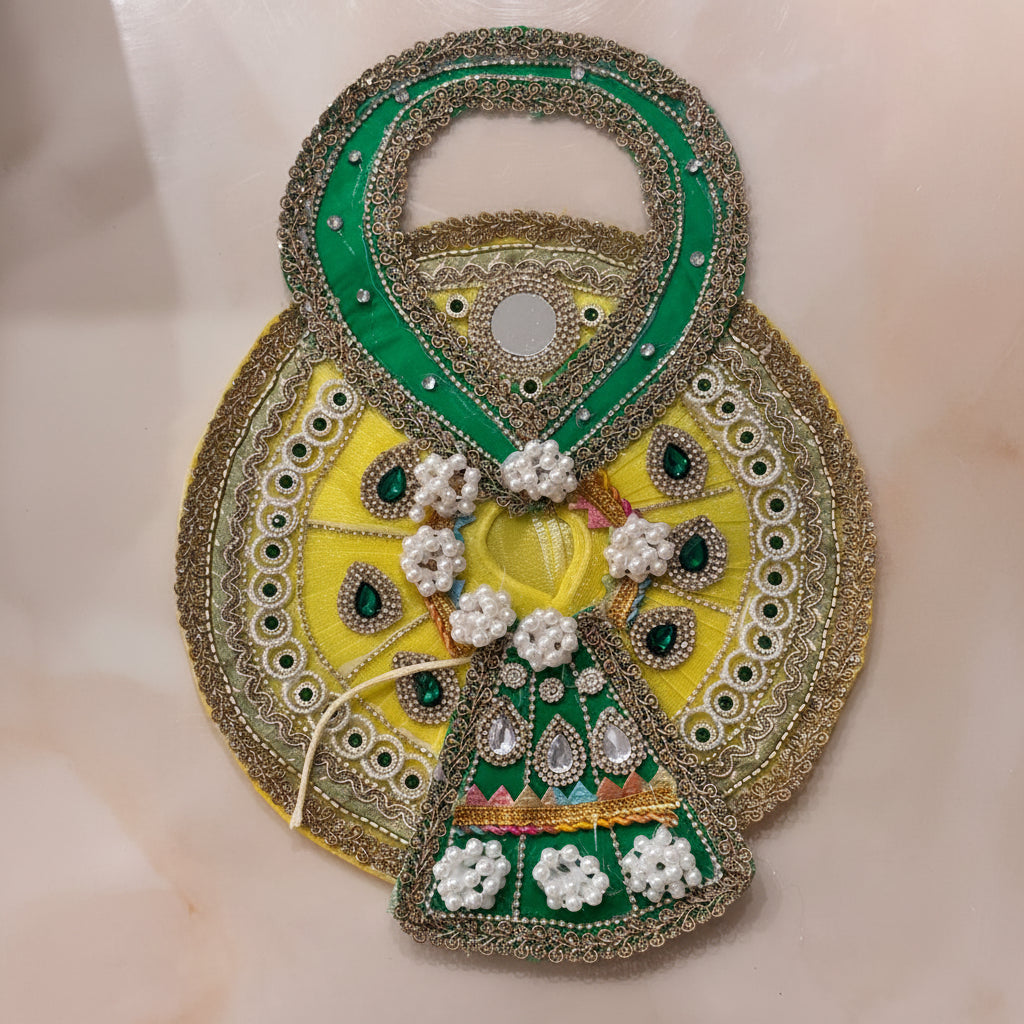 Handcrafted sunny yellow and emerald green designer dress and matching fan-shaped crown for Ladoo Gopal Ji, featuring pearl flowers and gemstones.