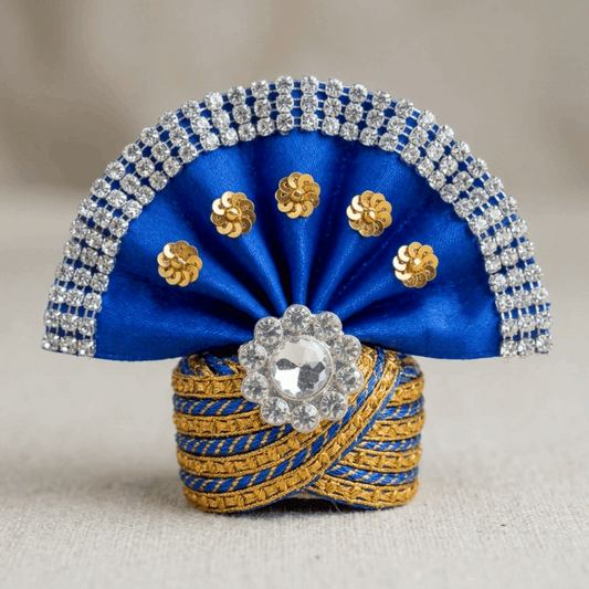 Decorative blue and gold item with crystals on a neutral background