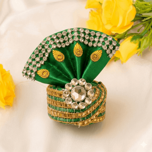 Decorative green and gold box with jewelry on a white background with yellow flowers.