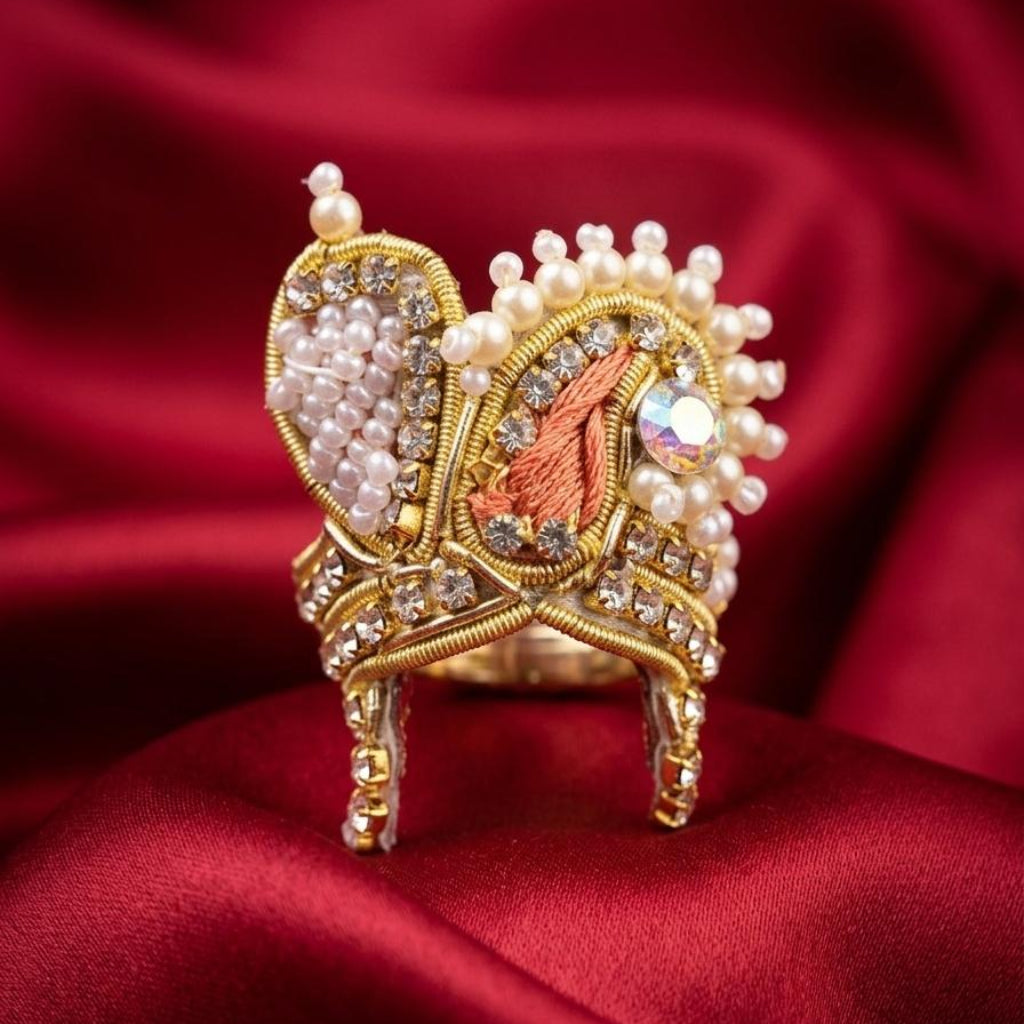 Handcrafted peach and pearl designer mukut for Ladoo Gopal Ji with gold zardosi and crystal accents.