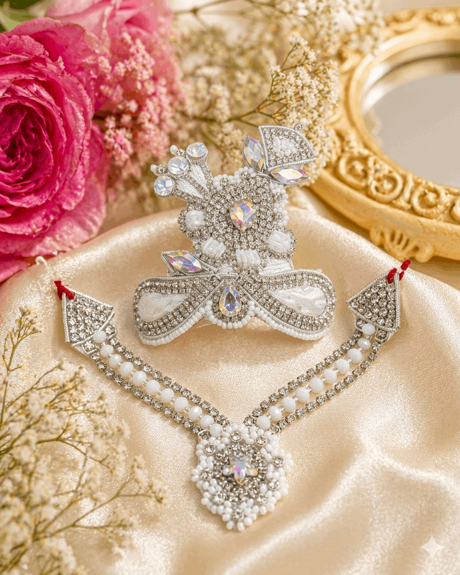 Decorative brooch with gemstones on a beige fabric background with pink roses and gold frame.