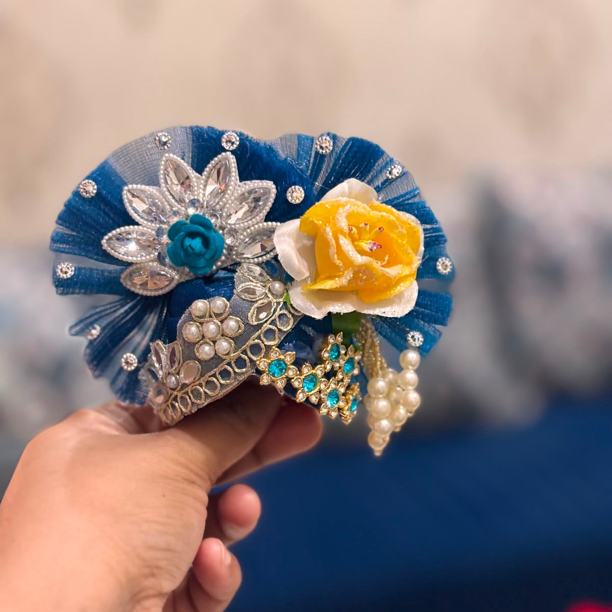 Handcrafted royal blue designer dress and matching crown for Ladoo Gopal Ji, featuring a deity appliqué, mirrors, and crystal star motifs.