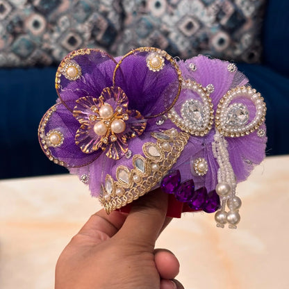 Handcrafted royal purple designer dress and matching crown for Ladoo Gopal Ji, featuring sacred cow appliqué, Krishna motifs, and pearl fringes.