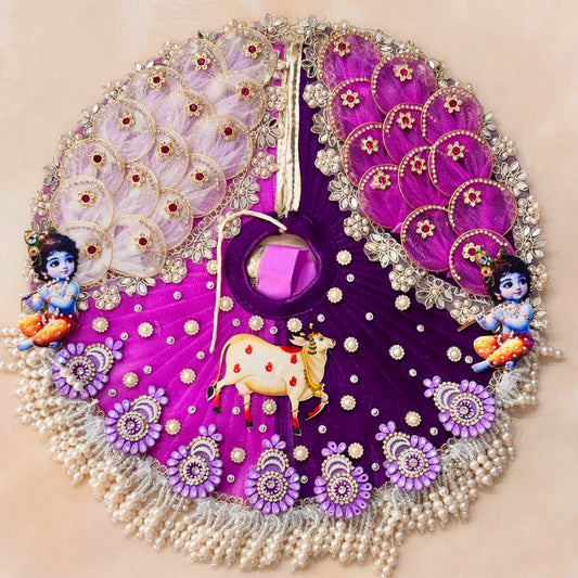 Handcrafted royal purple designer dress and matching crown for Ladoo Gopal Ji, featuring sacred cow appliqué, Krishna motifs, and pearl fringes.