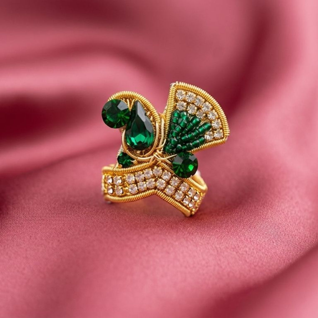 Handcrafted emerald and crystal designer mukut for Ladoo Gopal Ji with peacock-inspired beadwork.