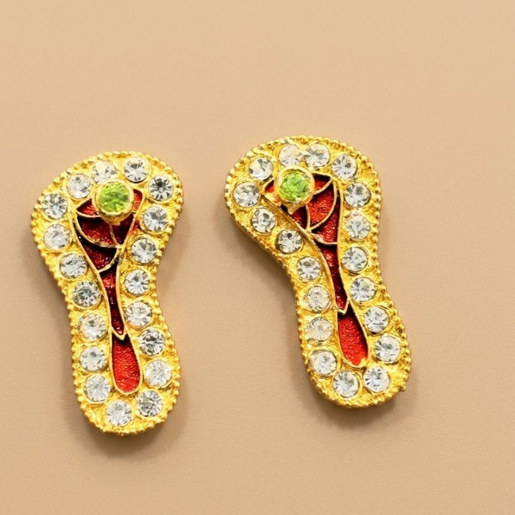 Royal Swarna Ratna Charan Paduka for Ladoo Gopal Ji featuring crimson enamel, crystal borders, and central stone detailing