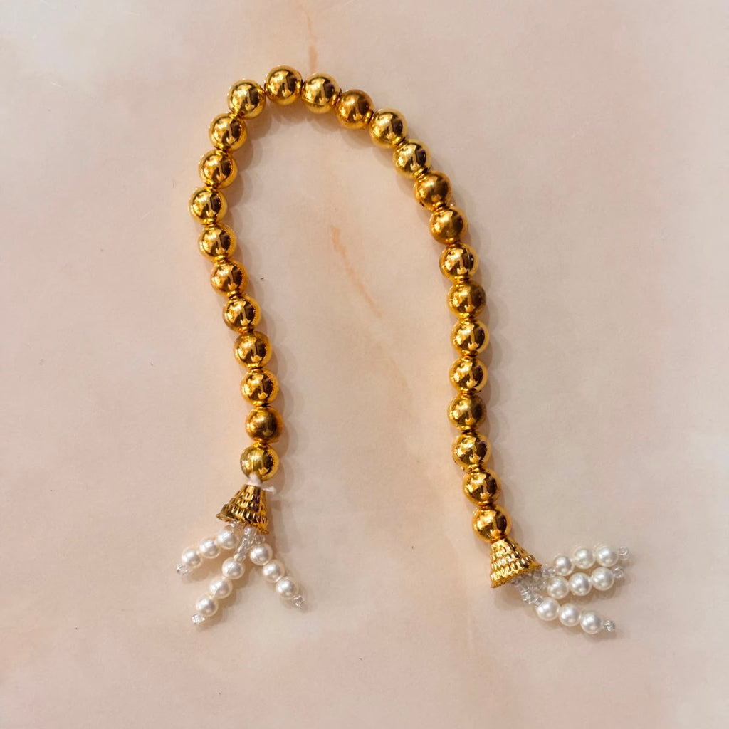 Handcrafted champagne gold and soft pink designer dress and matching crown for Ladoo Gopal Ji, featuring metallic embroidery and pearl detailing.