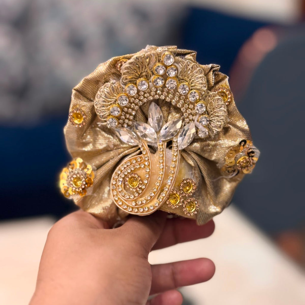 Handcrafted champagne gold and soft pink designer dress and matching crown for Ladoo Gopal Ji, featuring metallic embroidery and pearl detailing.