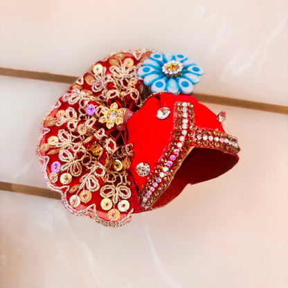 Decorative hair clip with floral and leaf designs on a white background