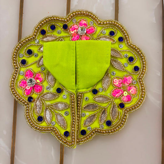 Decorative green patch with floral and leaf patterns on a white background