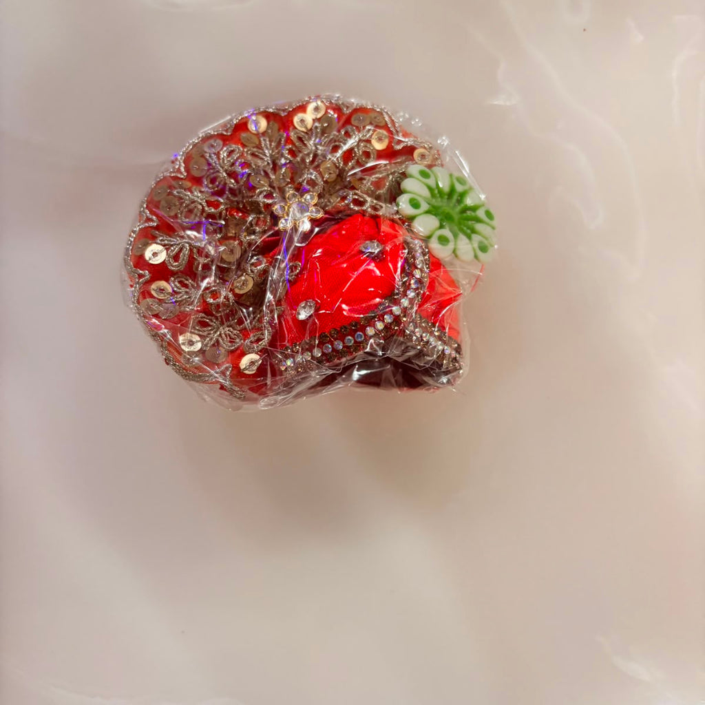 Decorative item with red center and floral patterns on a white surface