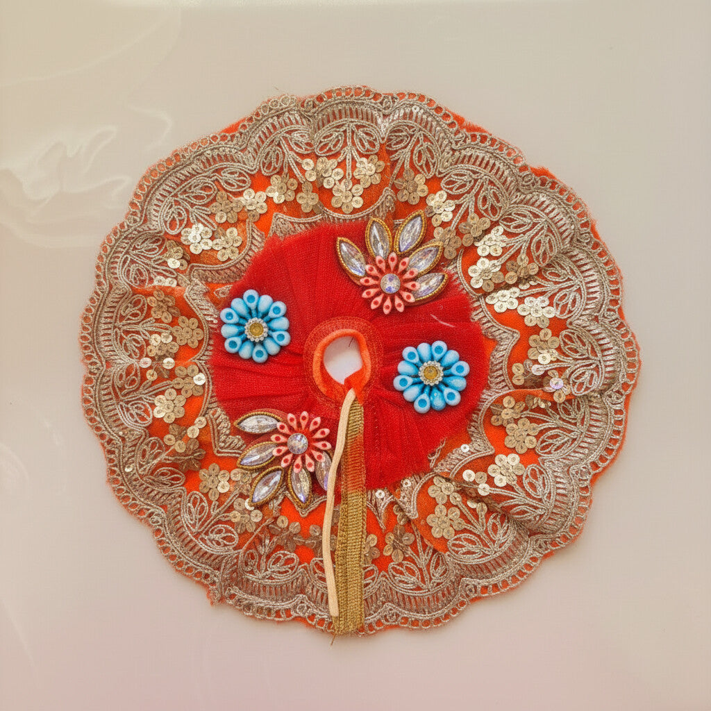 Decorative red fabric with gold embroidery and blue flowers on a white background